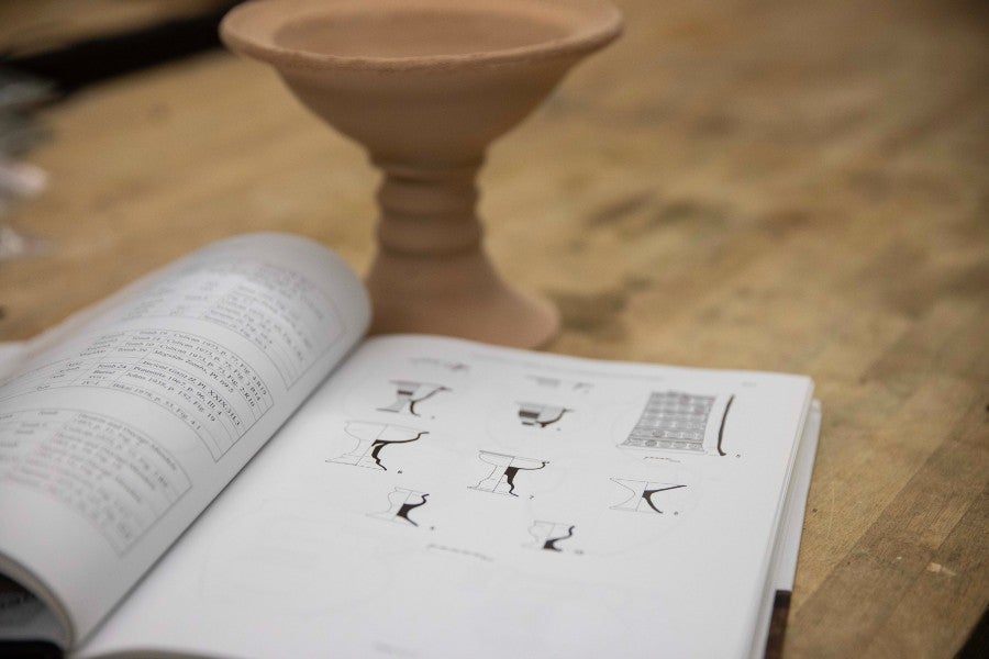 Book showing illustrations that archaeology students use to identify pottery compared to the 3-D printed replicas