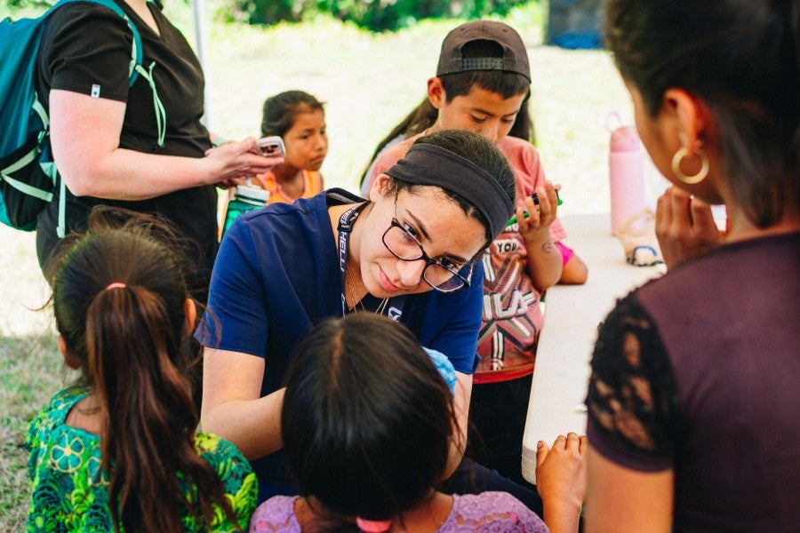 Lipscomb student nurse examining Guatemalan children