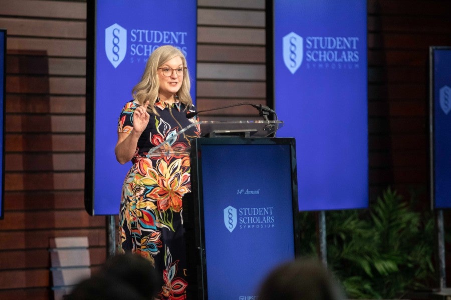 Keynote speaker at the podium at the symposium
