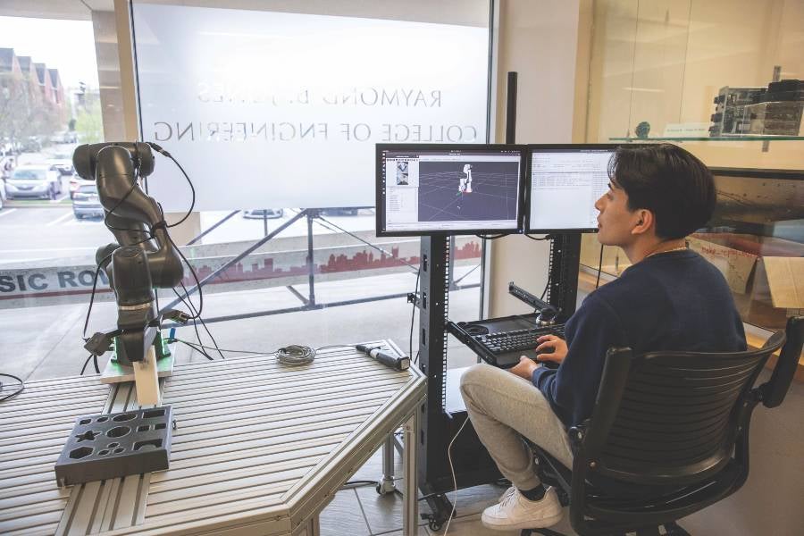 Student with robotic arm.