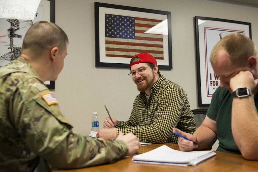 student talking to person in military uniform