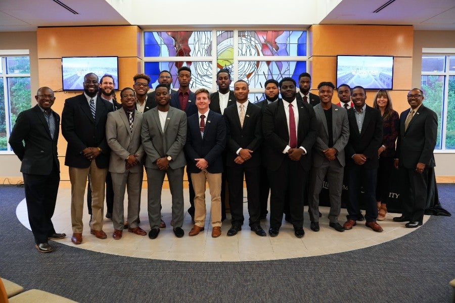 Group of college male students standing in for a group photo