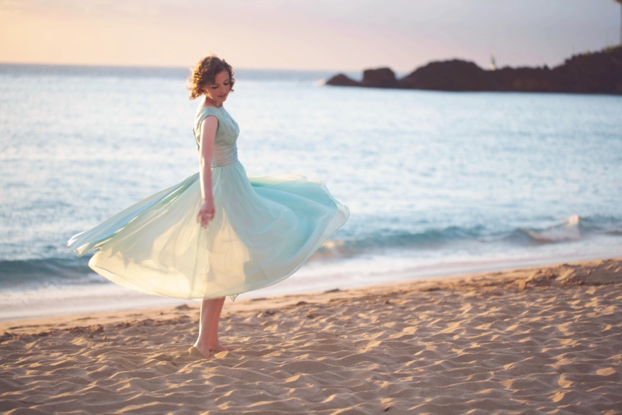 Emma Dryden twirling on a beach. 