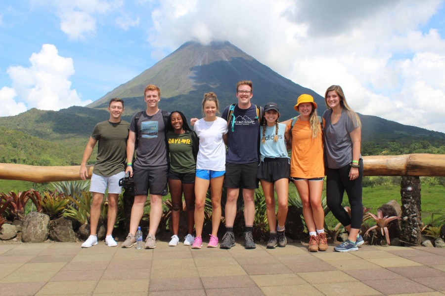 Students standing in front of a volcano.
