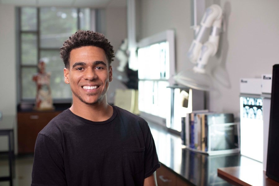 Deion Sims sits in biology lab