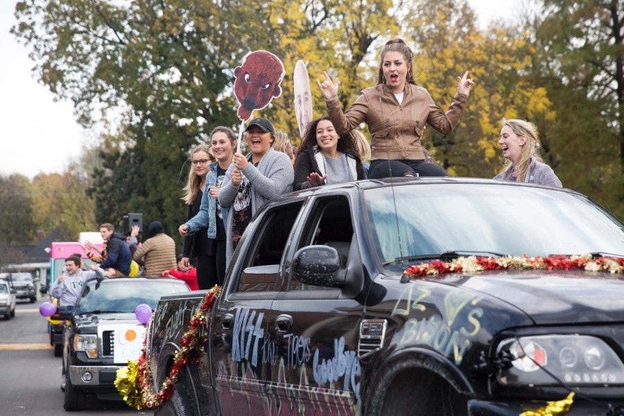 Students sitting in back of truck for Homecoming parade