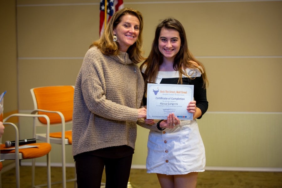 Maura Cunningham handing certificate to young lady