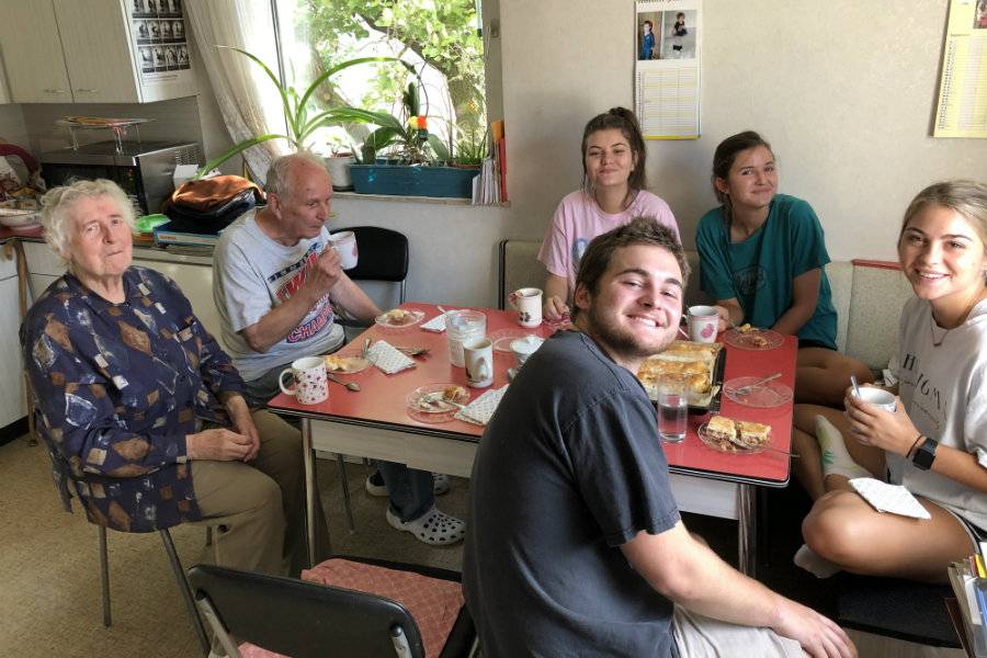 Students in Vienna at a table with residents of the city. 