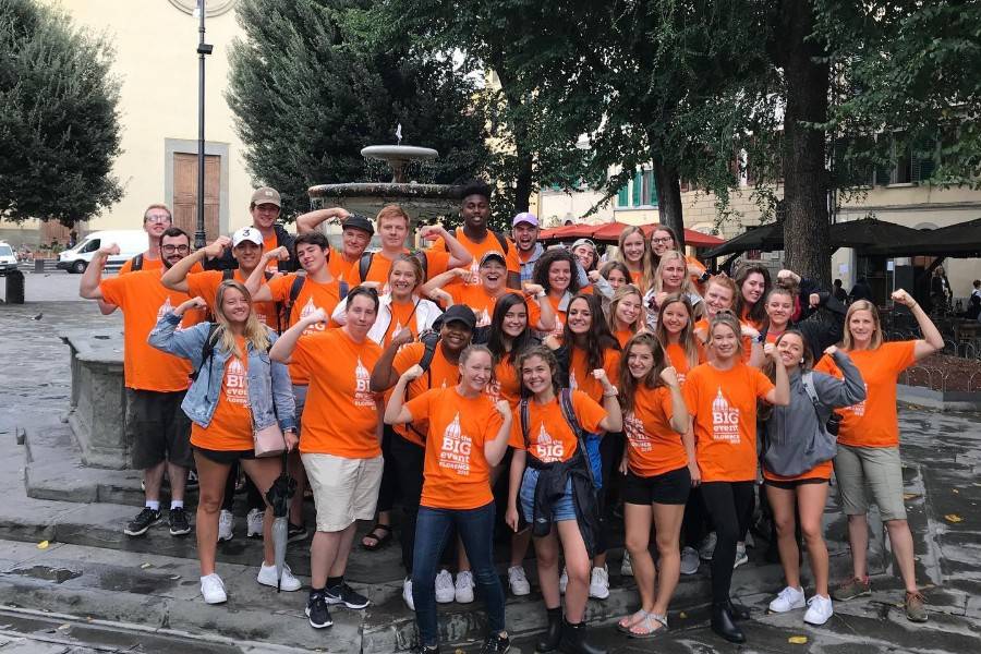 Groups of students in t-shirts on service day. 