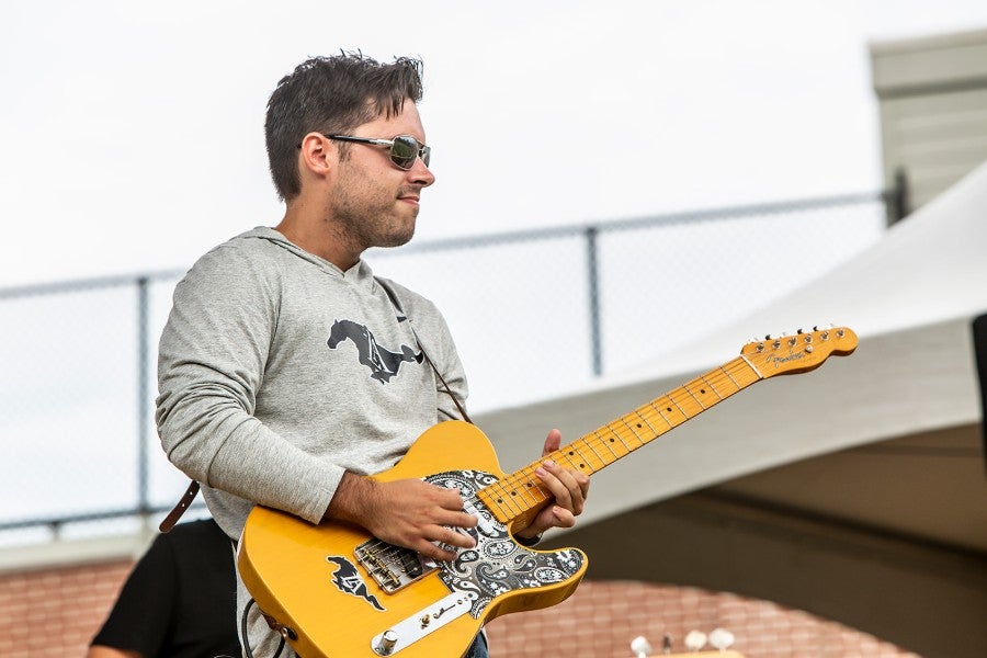 Patrick Carpenter playing guitar