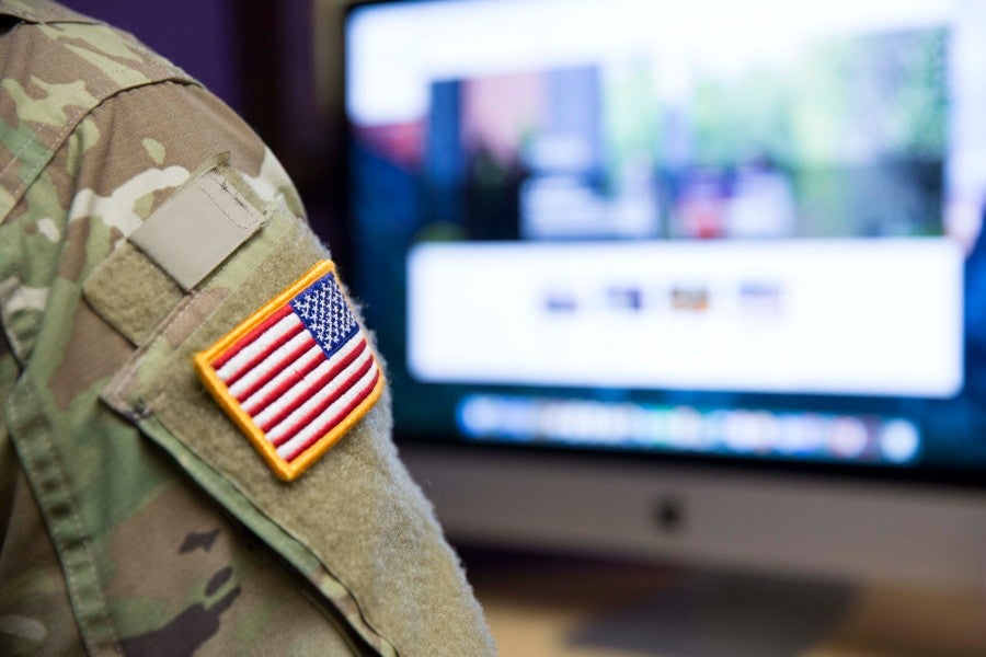 Picture of soldier sitting at a computer