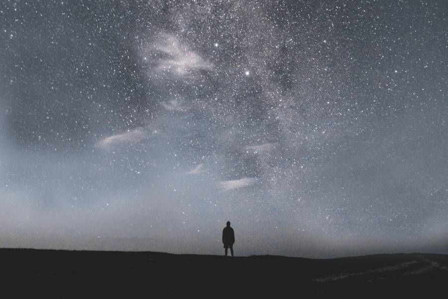 Photo of person looking at a starry sky