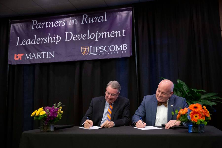 Lipscomb president Randy Lowry and UT Martin Chancellor Keith Carver signing agreement