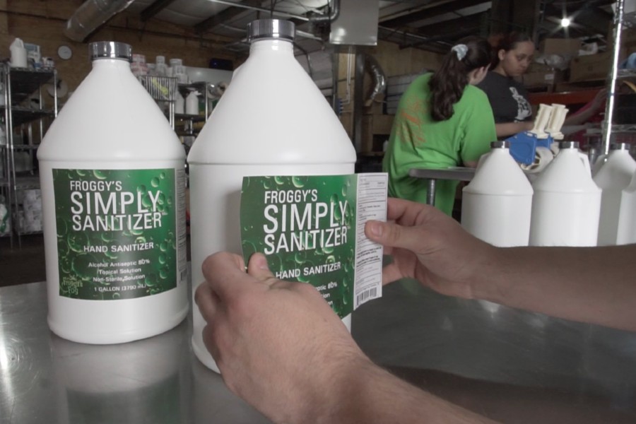 Labeling the bottles of Froggy's Fog Simply Sanitizer