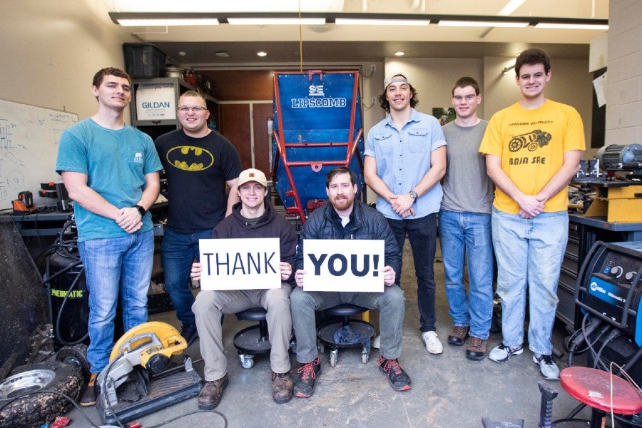 The Baja ATV team posing with a thank you sign to honor Nissan