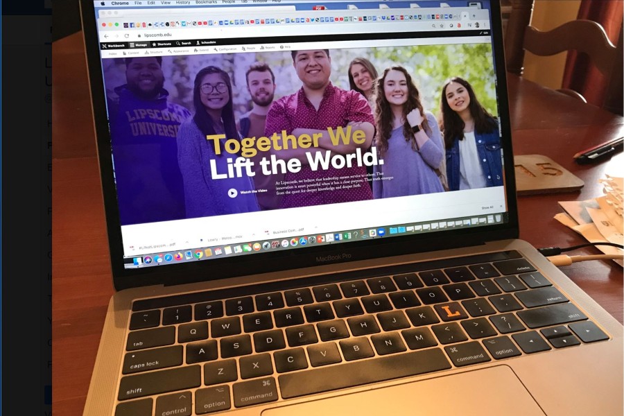 A laptop in a home showing the Lipscomb University home page