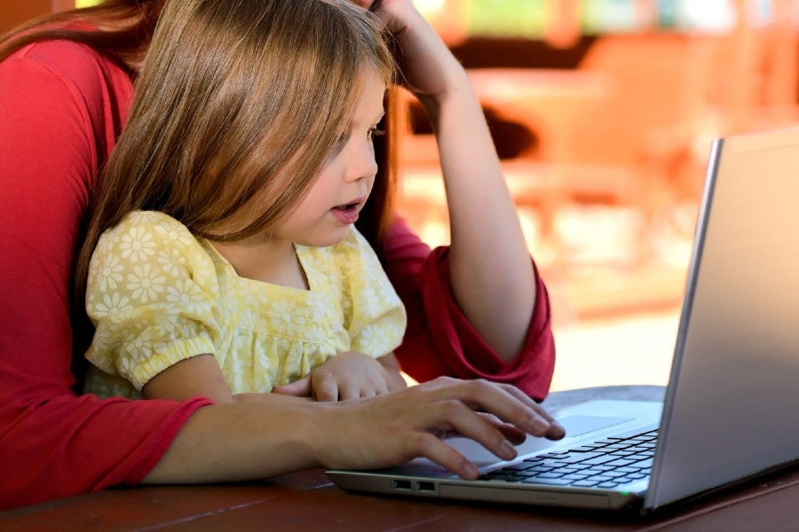 Parent and child at the computer at home