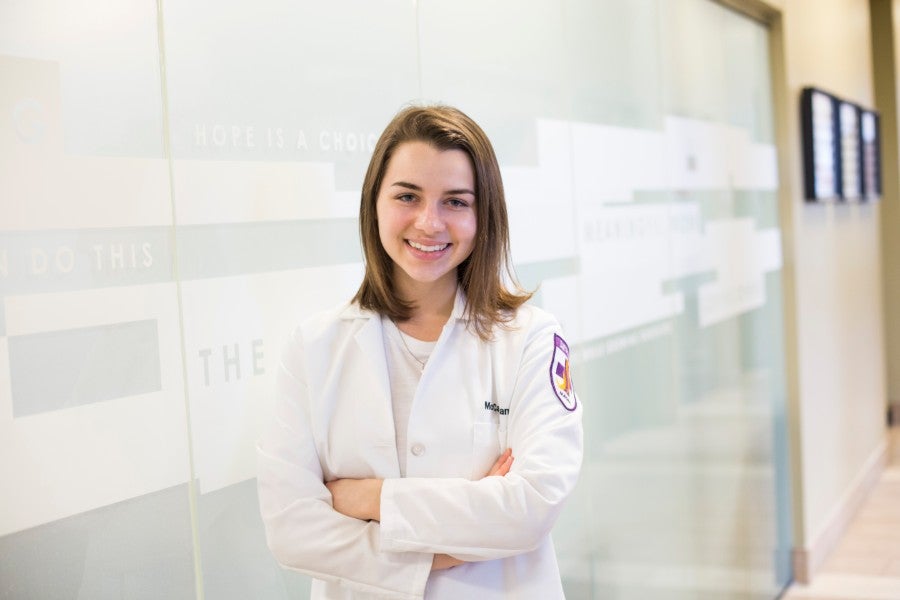 nursing student in white coat.