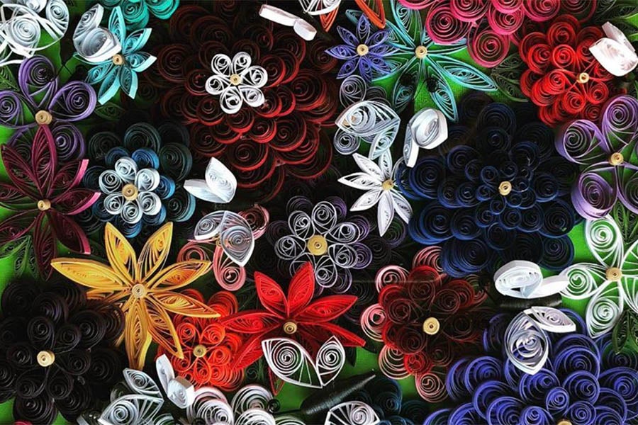 Quilled artwork of flowers and butterflies