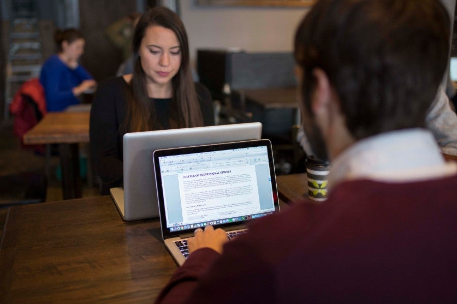 People on laptops at a cafe