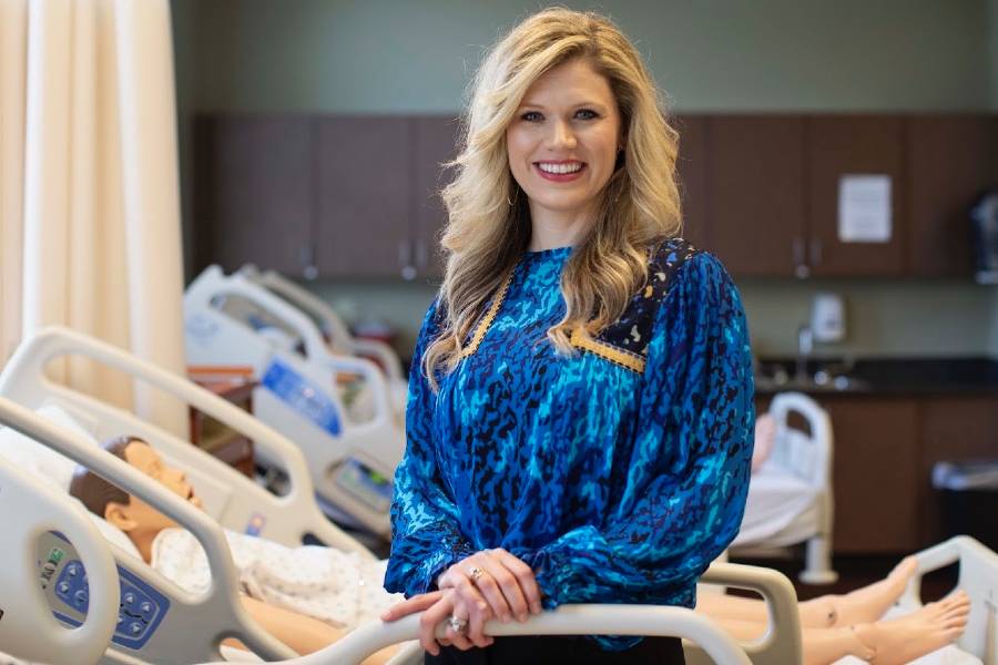 Chelsia Harris standing by patient bed