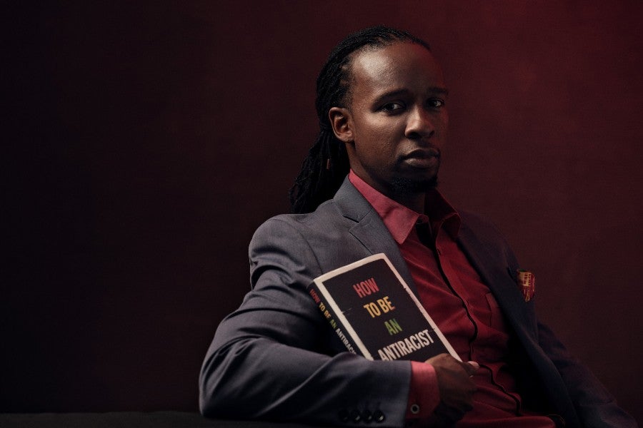 Author Ibram X. Kendi with his book