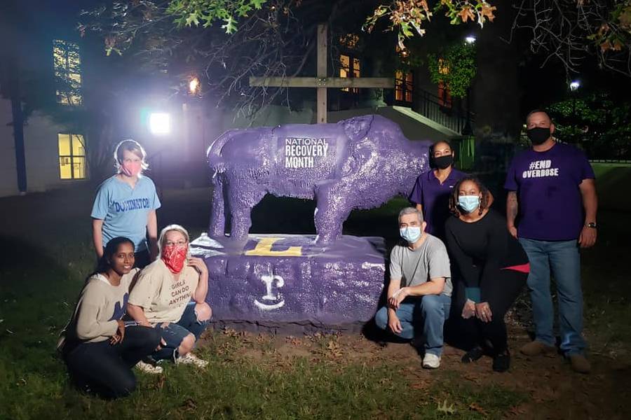 Graduate students sitting around Bison on campus