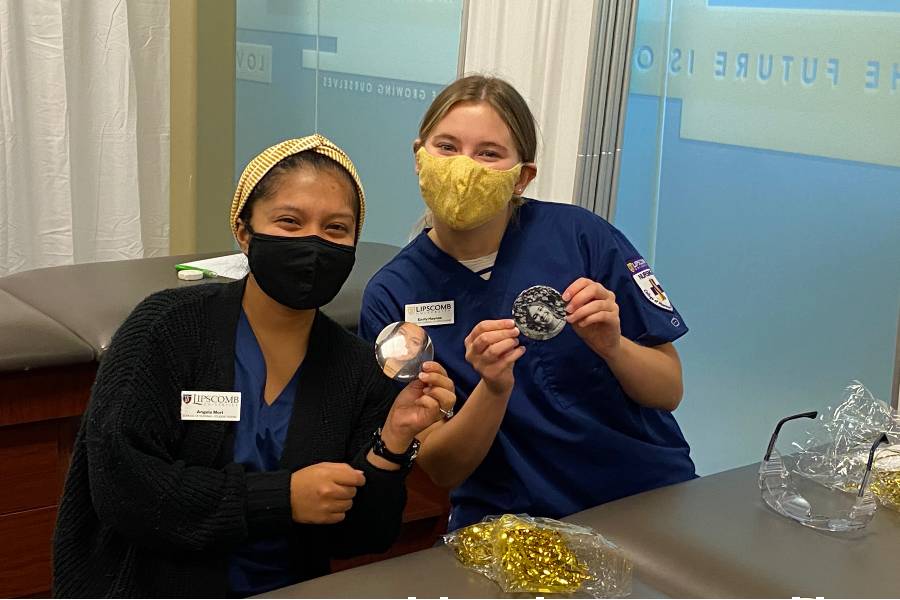 Photo of two nursing students wearing masks and buttons