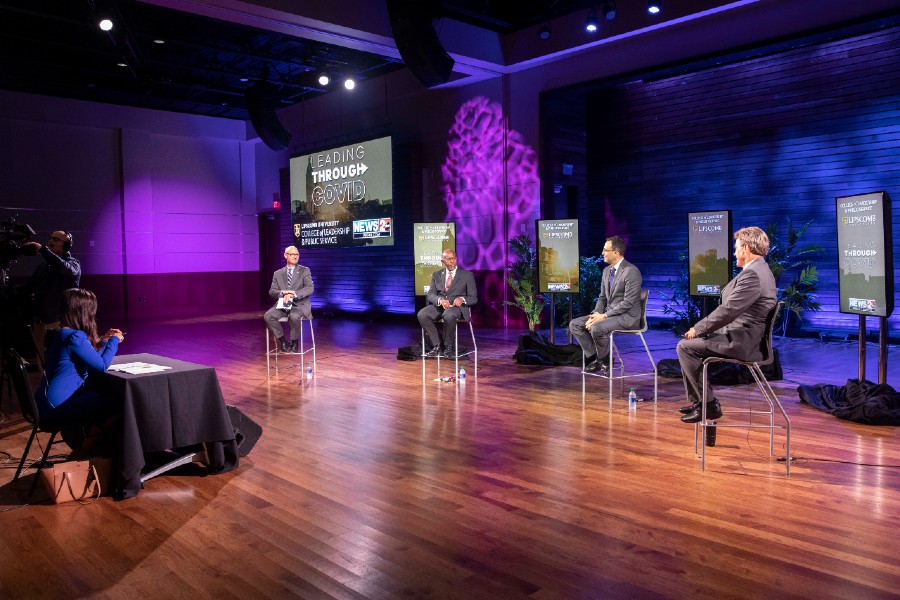 Panel members seated on stage