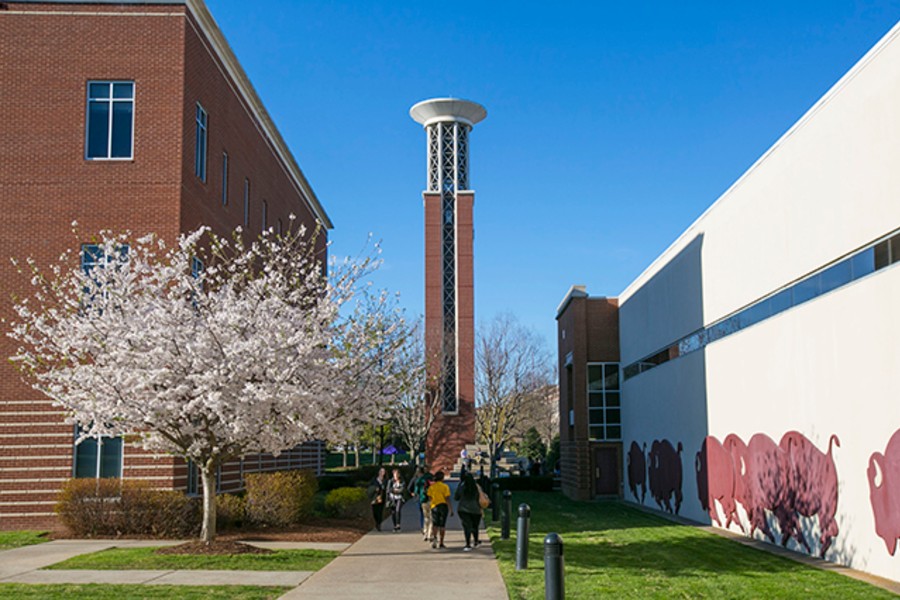 Belltower on campus with students