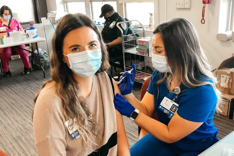 Morgan McDonald giving a vaccine