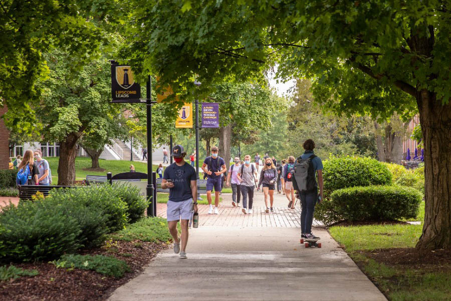 Students walking on campus wearing masks