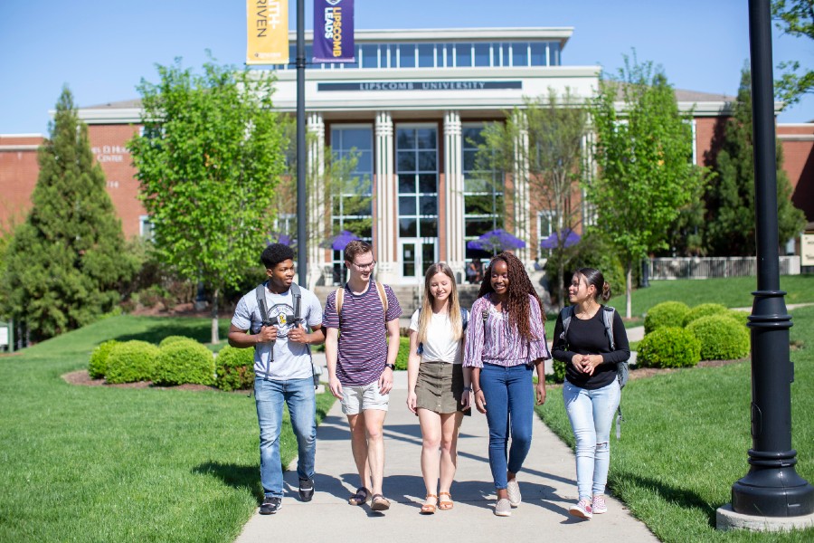 picture of four students walking on campus