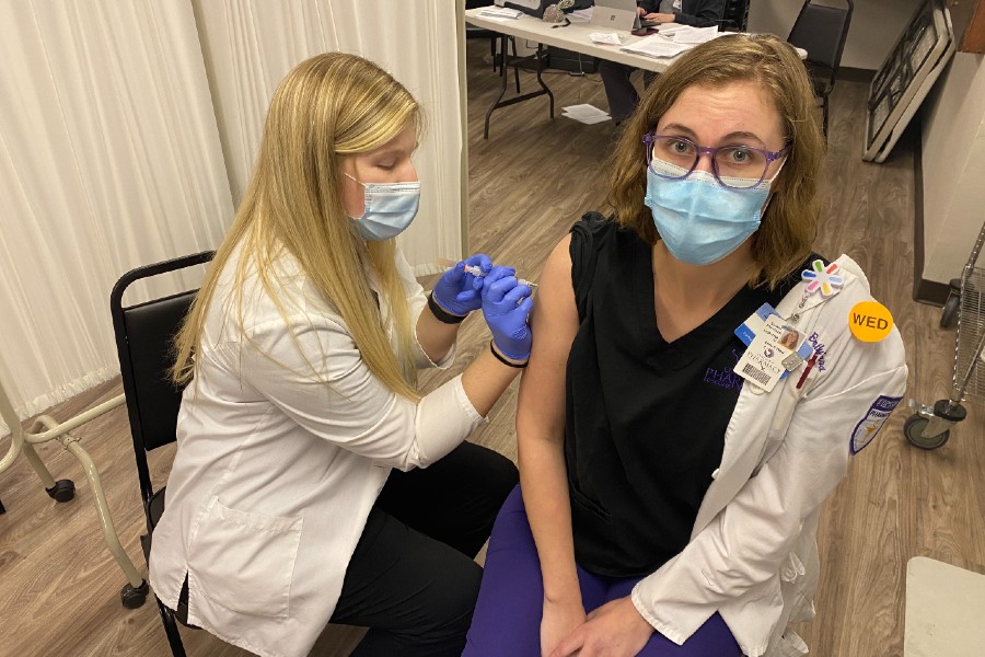 Olivia Garrett giving a Covid vaccine