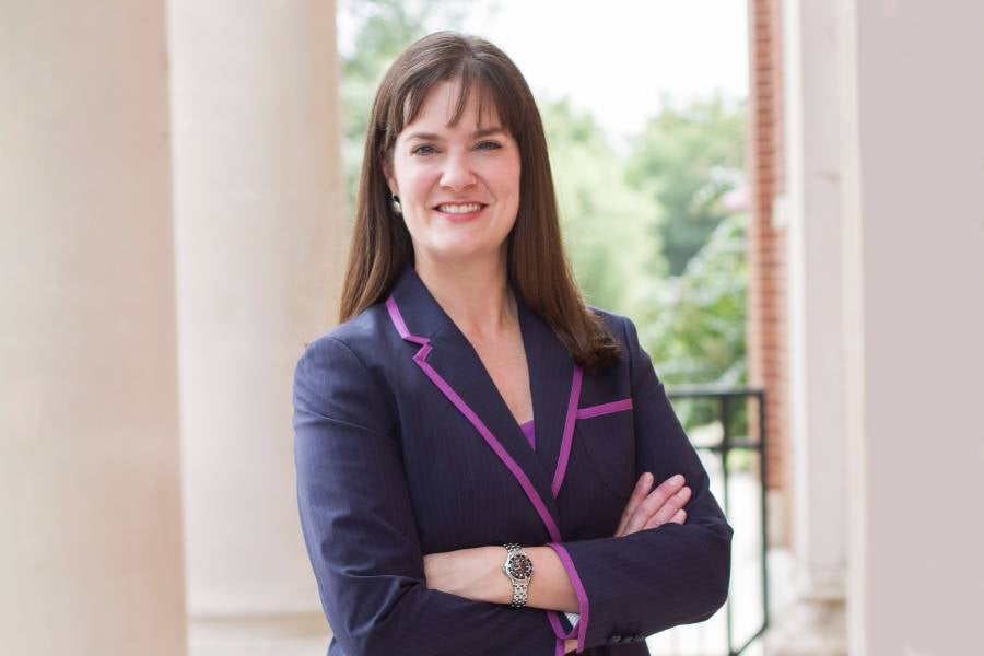 Dr. Candice McQueen standing by columns