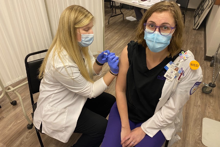 Pharmacy student giving a Covid vaccine