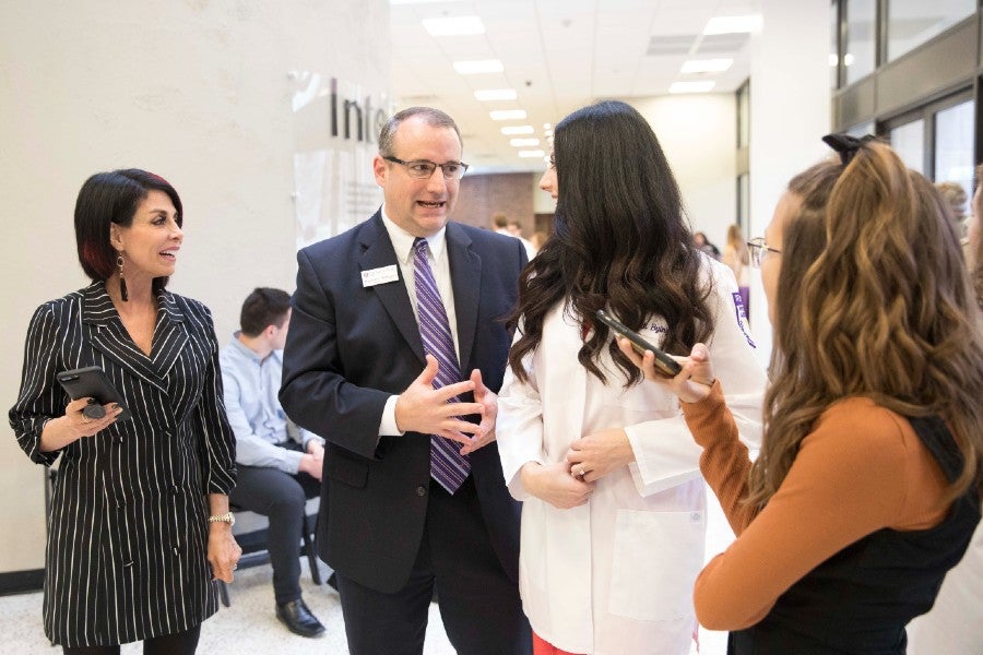 Stephen Heffington talking with students