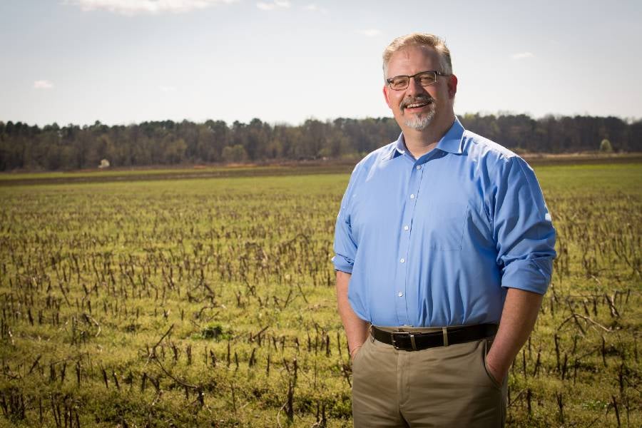 John Butler standing in a field