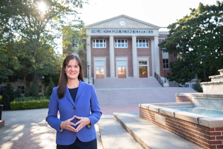 Dr. Candice McQueen in front of Collins Alumni Auditorium.