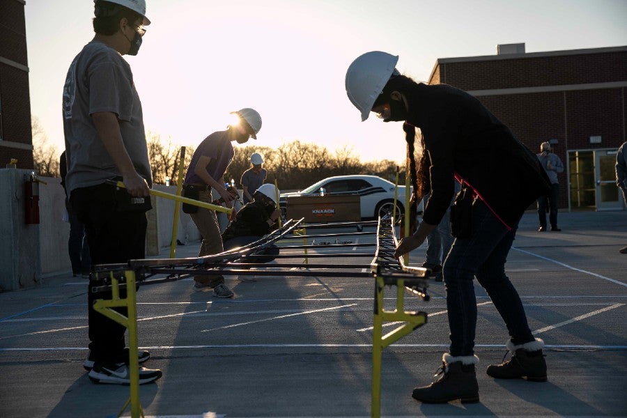 Students building a bridge on campus