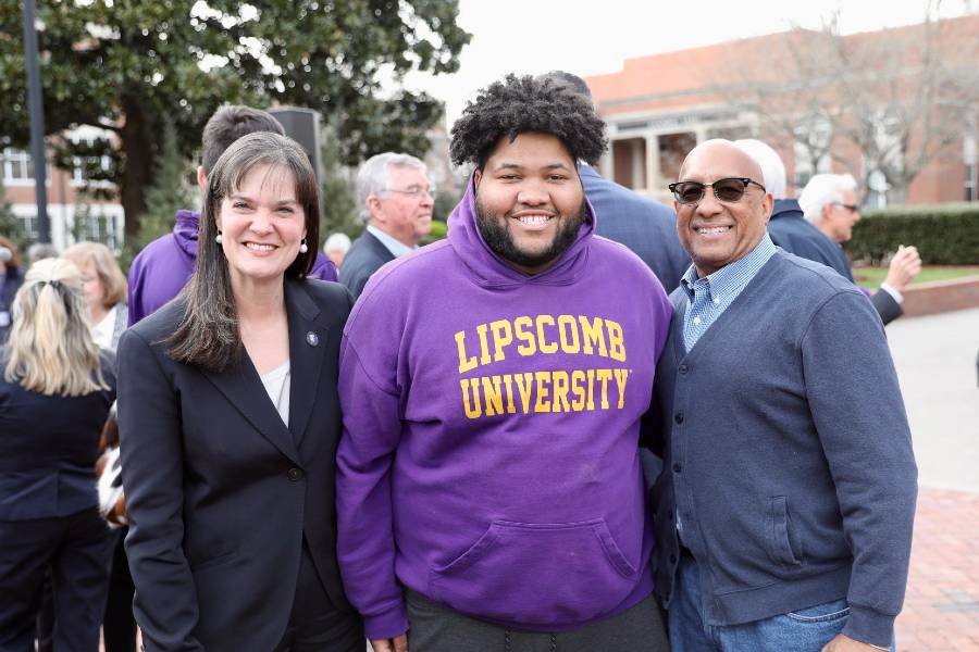 Dr. Candice McQueen with a student and his parent at the inauguration devotional on the steps of Collins. 