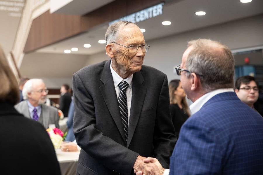 Paul Langford greeting guests at dinner