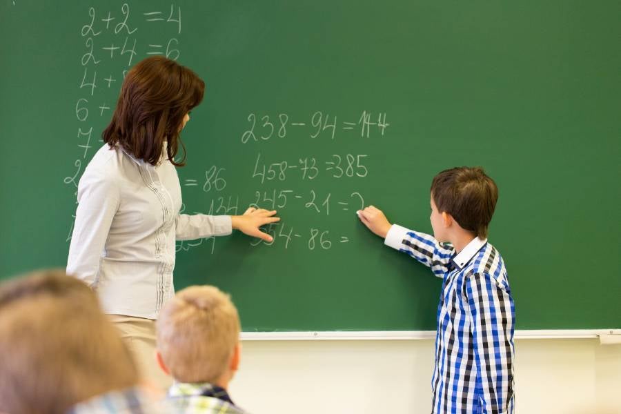 Teacher with a student in math class