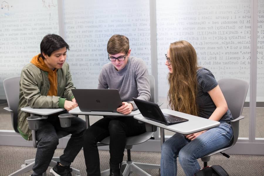 Students studying around a computer