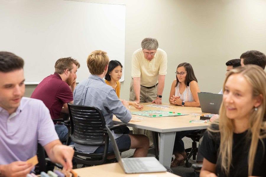 Perry Moore with students playing Monopoly