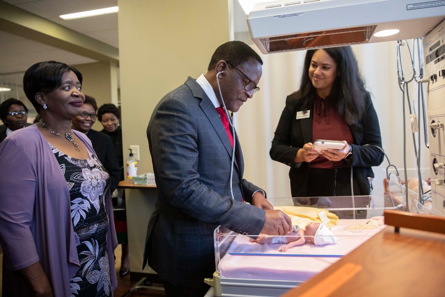 Malawi President Dr. Lazarus Chakwera listens to the simulated heartbeat of a preemie patient simulator