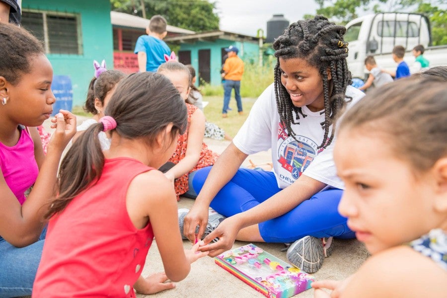 Lipscomb student with children on a missions trip