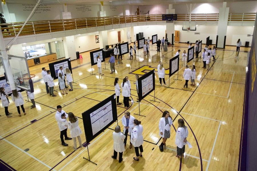 Scholars Day posters and presenters in McQuiddy Gym