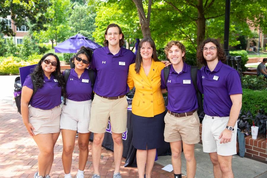 Quest team students with President McQueen in Bison Square