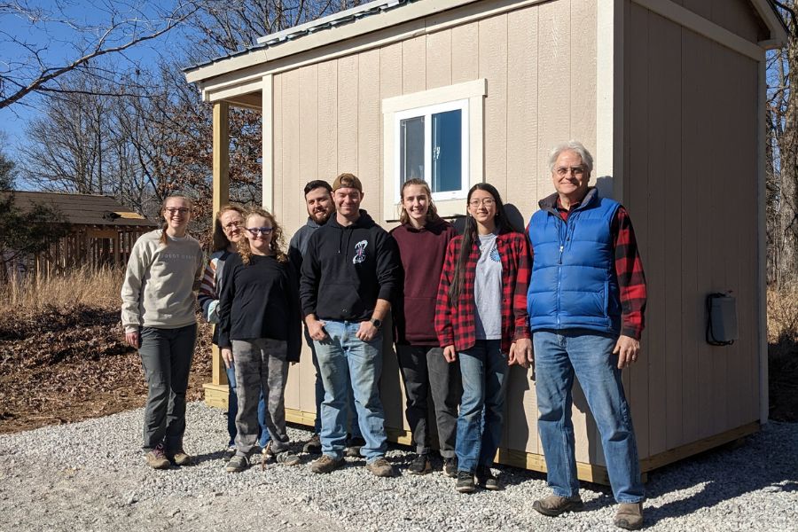 Dean Elrod and engineering student and faculty in front of the completed, delivered microhome